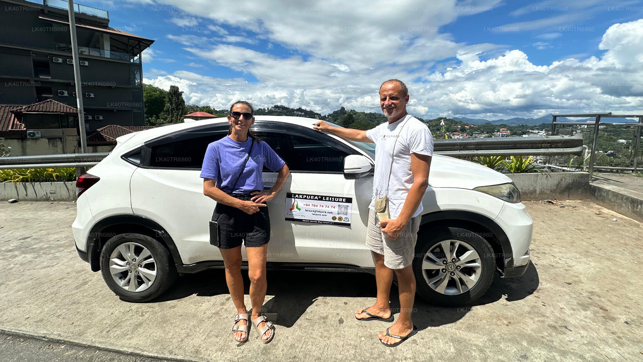 Two people standing next to a white SUV with a visible brand logo on a sunny day.