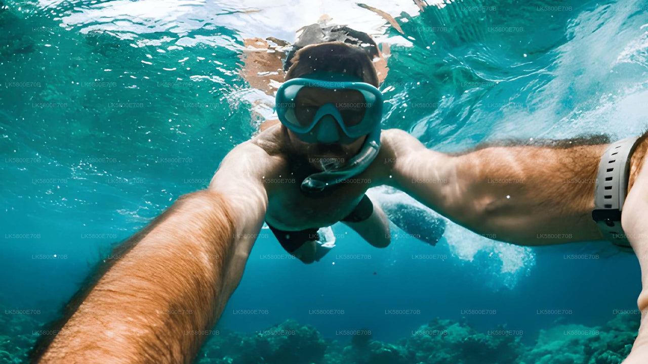 Person holding a child underwater in clear blue water